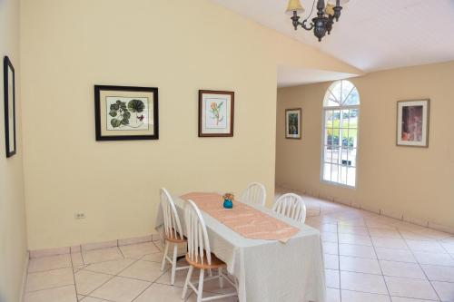 a dining room with a table and chairs at Uyuca Vista Family Villa in Tegucigalpa