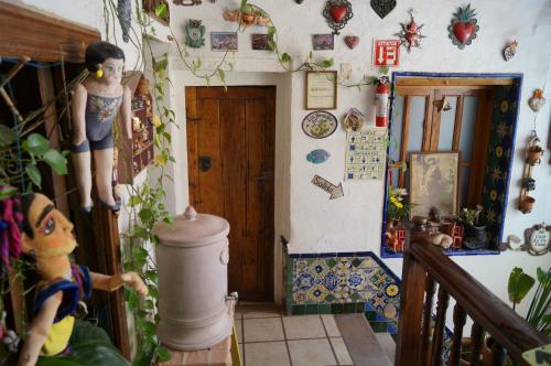 a room with a hallway with a door and a doll at Casa de Pita in Guanajuato