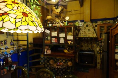 a room with a shop with a table and a lamp at Casa de Pita in Guanajuato