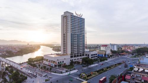 a city with a tall building and a river at Muong Thanh Luxury Ha Nam in Phủ Lý