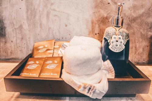 a table with towels and a bottle of alcohol at Langkhai Garden in Koh Tao