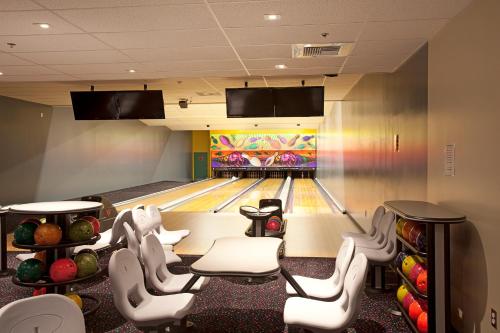 a bowling alley with pins and bowling lanes at Holland Inn and Suites in Taft