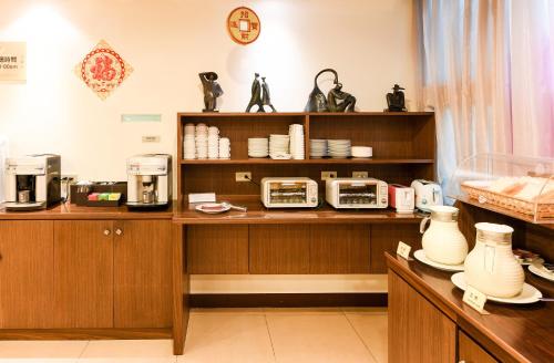 a kitchen with a counter with appliances on it at Hwu Meei Motel in Tainan