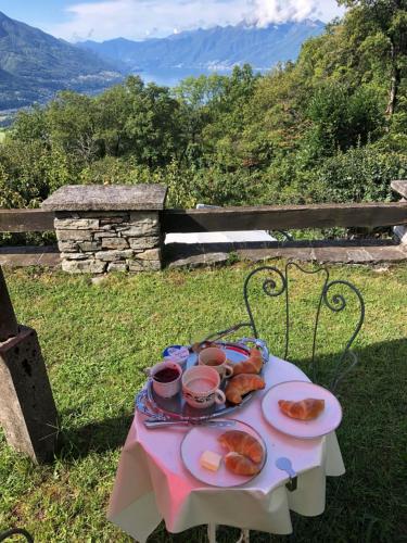 a table with a plate of food on it at Helle Sonne in Agarone