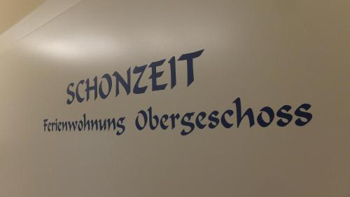 a sign on a wall with the wordsstudent transforming diseasesbestos at Ferienwohnung "Schonzeit" in Graal-Müritz