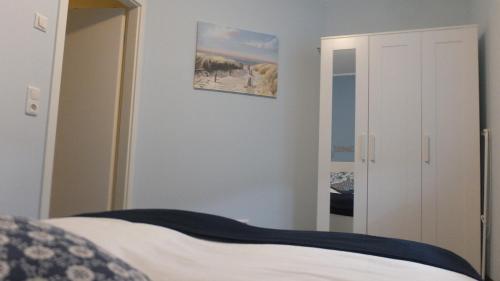 a bedroom with a bed and a mirror at Ferienwohnung "Schonzeit" in Graal-Müritz