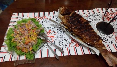a table with a plate of food and a salad at Precious Residence C in Grand'Anse
