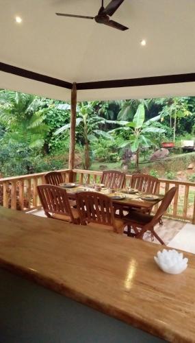 a dining room with a table and chairs at Precious Residence C in Grand'Anse