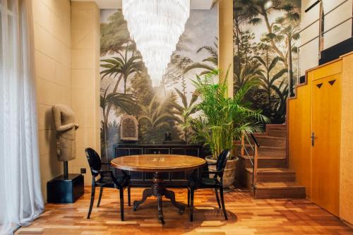 a dining room with a table and chairs and a mural at Claris Hotel & Spa GL, a Small Luxury Hotel of the World in Barcelona