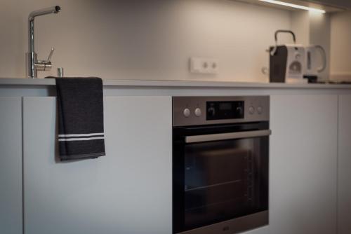 a kitchen with a counter with a stove top oven at ride & relax Aparthotel Schwarz in Eben im Pongau