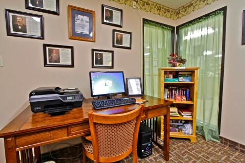 an office with a desk with a computer and a printer at Governors Inn a Travelodge by Wyndham in Pierre
