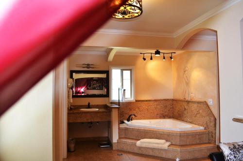 a large bathroom with a tub and a sink at Chardonnay Lodge in Napa