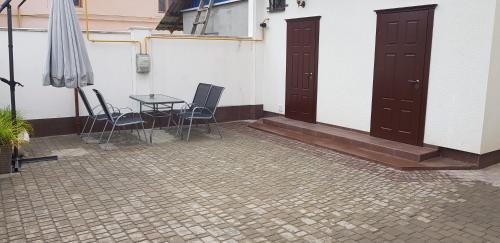 a patio with a table and two chairs and an umbrella at Apartment in Balti in Bălţi