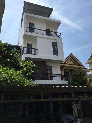 a tall white building with balconies on top of it at candyinn in Hue