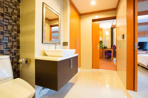 a bathroom with a sink and a toilet at Romantic Khon Kaen Hotel in Khon Kaen