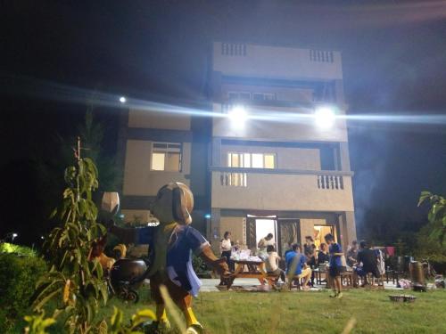 a group of people in front of a house at night at 好宿民宿 in Jinning