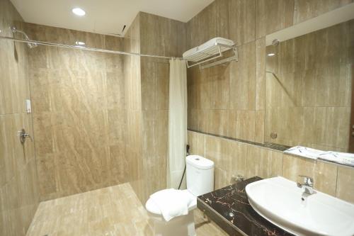 W łazience znajduje się toaleta, umywalka i prysznic. w obiekcie Horison Express Sentani w mieście Jayapura