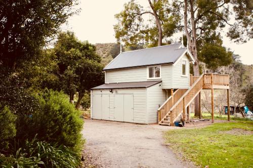 a small white house with a ramp leading up to it at The Signal Box in Whanganui