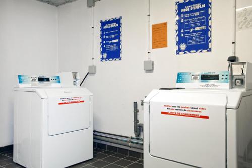 two refrigerators sitting next to each other in a room at Séjours & Affaires Reims Clairmarais in Reims