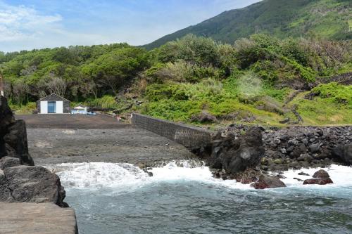 a bridge over a river with a mountain at Casa dos Botes - WhaleBoat House TER in São Caetano