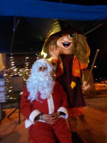 a man dressed as santa claus is standing next to a man in at Casa Santa Maria in Folgaria