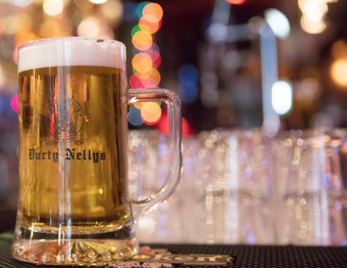 a glass of beer sitting on a table at Durty Nelly's Inn in Amsterdam
