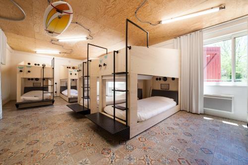 a room with four bunk beds in it at JO&JOE Hossegor in Hossegor