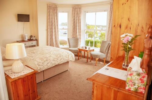 a hotel room with a bed and a window at Burford Lodge Guest House in Ardglass