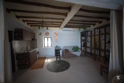 a large living room with wooden ceilings and a table at Komissa΄s Beach House in Agia Pelagia