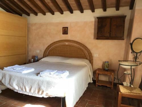 a bedroom with a bed with towels on it at Casa Laura in Cortona