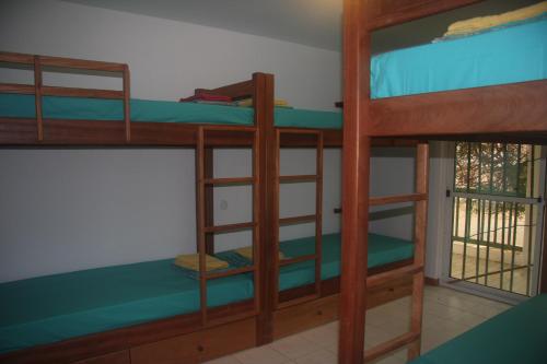 a room with two bunk beds and a window at Surf House Hostel in Santa Maria