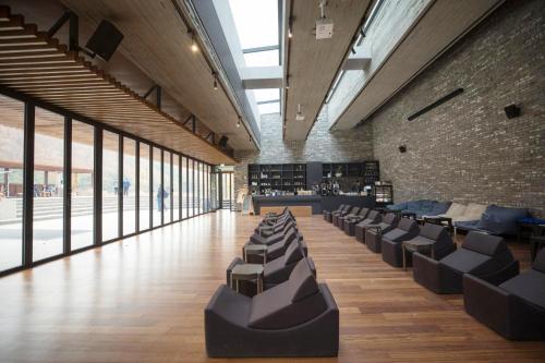a large room with chairs and a brick wall at Healience Village in Hongcheon