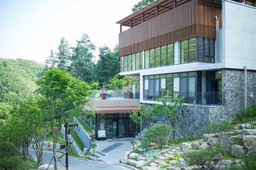 a large building with a walkway in front of it at Healience Village in Hongcheon