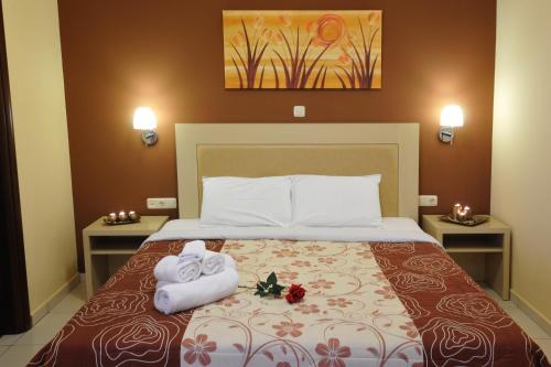 a hotel room with a bed with towels on it at Faros Luxury Suites in Marathopolis