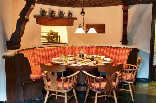 a dining room with a table and chairs at Steigenberger Airport Hotel Frankfurt in Frankfurt/Main