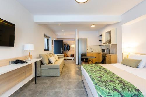 a hotel room with a bed and a couch at T Hotel Premium Suites in Balíon