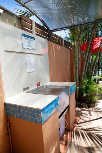a bathroom with a counter with blue tiles on it at Karana Palms Resort in Gold Coast