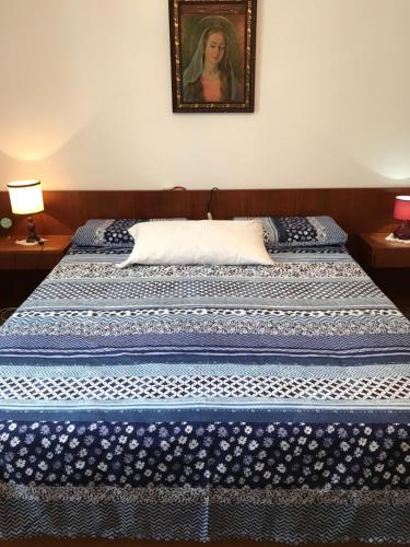 two beds in a room with a picture on the wall at Bed & Breakfast Casa Marinella in Lenna