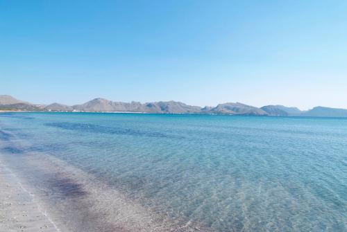 a view of a beach with mountains in the background at PortBlue Club Pollentia Resort & Spa in Alcudia