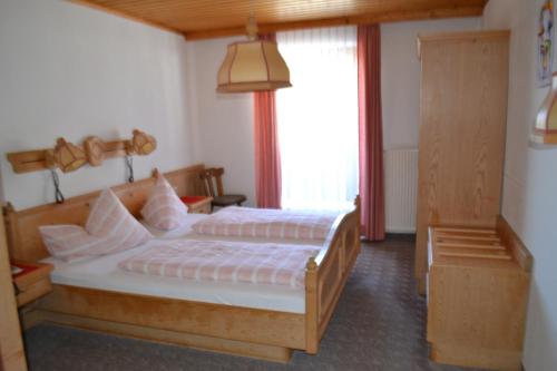 A bed or beds in a room at Innviertler Berggasthof