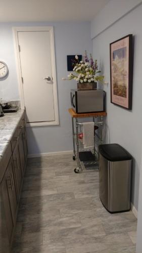 a kitchen with a counter and a door and a table at Casa Tranquility in San Diego