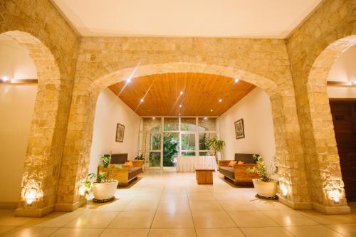 a large room with a stone wall and a lobby at Moringa Hotel in Toliara