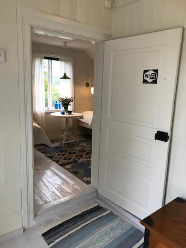 a door leading into a room with a living room at Perssons Magasin in Västra Löa