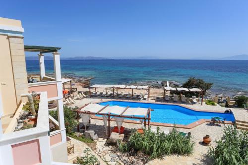 a view of a swimming pool and the ocean at Irides in Souvala