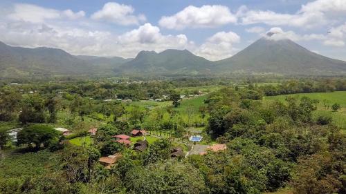 an aerial view of a mountain with a village and trees at Hotel Eco Arenal in Fortuna