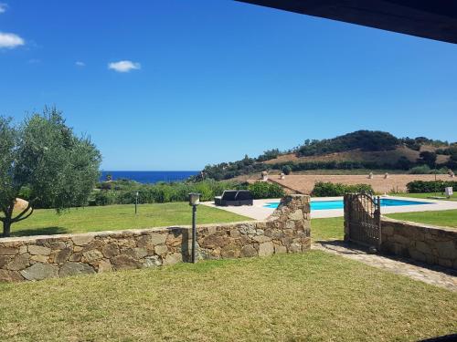 a view of a stone wall and a swimming pool at Abba Urci in Tertenìa