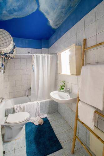 a bathroom with a toilet and a sink and a tub at Dream Catcher Artemis in Artemida