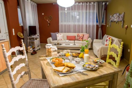 a living room with a table with food on it at Dream Catcher Artemis in Artemida