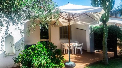 a patio with an umbrella and a table at Appartamenti Luongo in Ischia