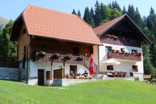 a house with people sitting outside of it at Penzion Pr' Betel in Jesenice